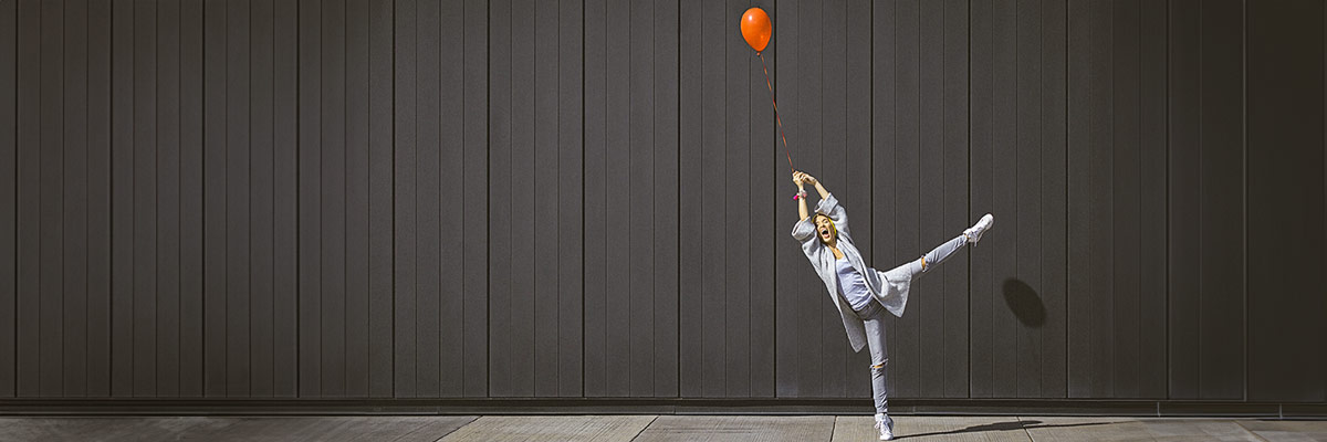 Woman holding a red ballon