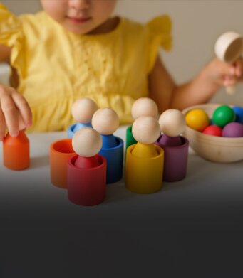 Child playing with wooden toys